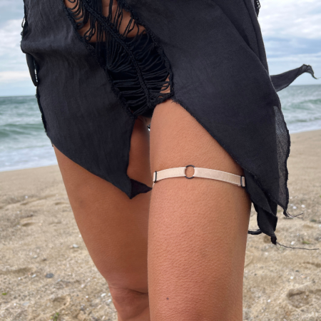 Accessorize your look with a beige thigh harness accessory.