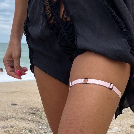 Accessorize your style with a pink thigh harness garter